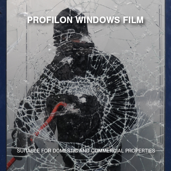 A masked intruder attempting to break through a glass window reinforced with Profilon Windows FIM, showing extensive cracking but no breach.