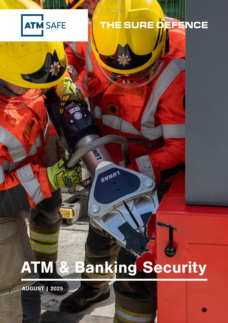 Firefighters using heavy hydraulic equipment to cut into a secure ATM enclosure during a security demonstration or breach simulation.